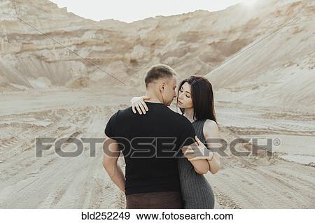 Stock Photo - Middle Eastern couple kissing in the desert. Fotosearch