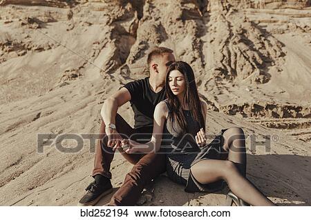 Middle Eastern couple sitting in desert View Large Photo Image Picture - Middle Eastern couple sitting in desert. Fotosearch