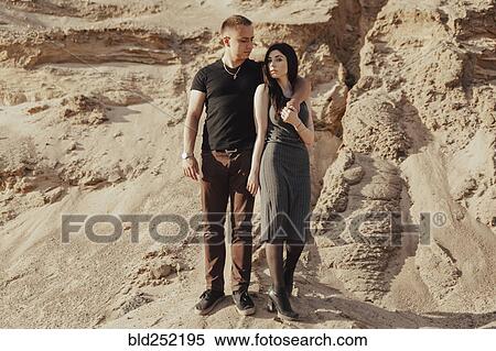 Stock Photography - Middle Eastern couple standing in desert. Fotosearch