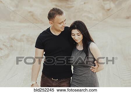 Stock Photography - Middle Eastern couple walking in the desert. Fotosearch