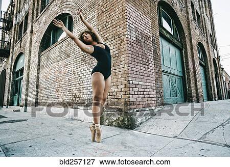 Mixed race ballet dancer on sidewalk in city View Large Photo Image Stock Photo - Mixed race ballet dancer on sidewalk in city. Fotosearch