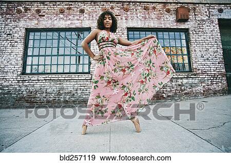 Mixed race ballet dancer wearing dress on sidewalk View Large Photo Image Stock Photo - Mixed race ballet dancer wearing dress on sidewalk. Fotosearch