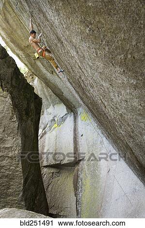 Mixed race boy climbing rock View Large Photo Image Stock Image - Mixed race boy climbing rock. Fotosearch