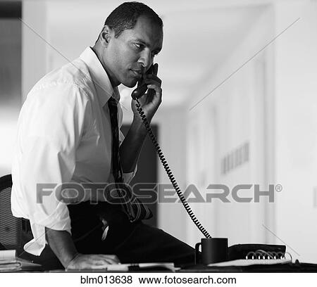 Mixed race businessman talking on telephone View Large Photo Image Stock Photo - Mixed race businessman talking on telephone. Fotosearch