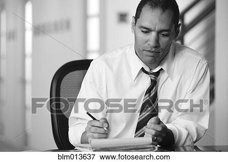 Mixed race businessman working at desk View Large Photo Image Stock Photo - Mixed race businessman working at desk. Fotosearch