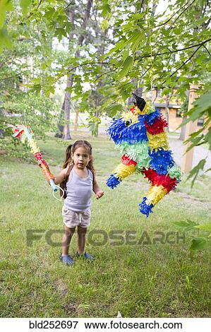 Mixed race girl hitting pinata outdoors View Large Photo Image Stock Photo - Mixed race girl hitting pinata outdoors. Fotosearch
