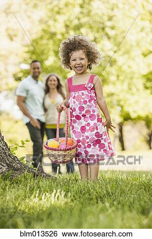 Mixed race girl on Easter egg hunt View Large Photo Image Stock Photograph - Mixed race girl on Easter egg hunt. Fotosearch