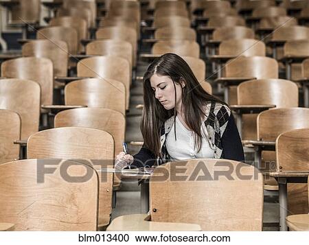 Stock Image - Mixed race student studying in classroom. Fotosearch