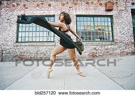 Mixed race woman dancing ballet on sidewalk View Large Photo Image Stock Image - Mixed race woman dancing ballet on sidewalk. Fotosearch
