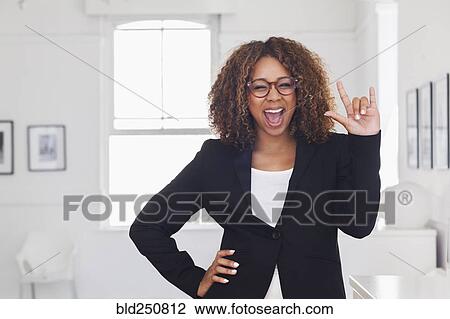 Stock Image - Mixed race woman gesturing in gallery. Fotosearch