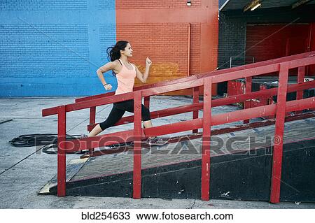 Mixed race woman running up loading dock View Large Photo Image Stock Image - Mixed race woman running up loading dock. Fotosearch