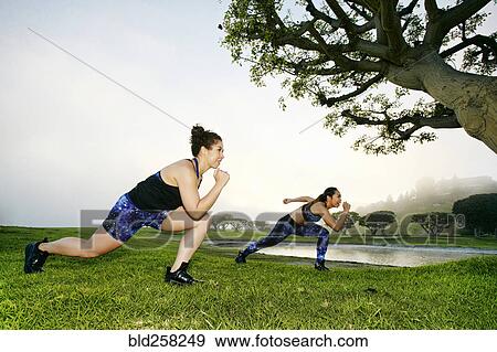 Mixed race women exercising near lake View Large Photo Image Stock Photo - Mixed race women exercising near lake. Fotosearch