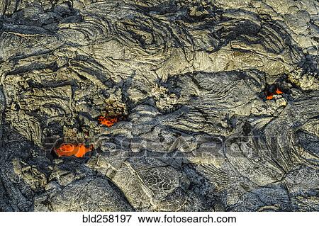 Stock Photo - Molten lava glowing near dried lava. Fotosearch