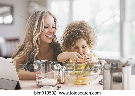 Mother and daughter baking together View Large Photo Image Stock Image - Mother and daughter baking together. Fotosearch