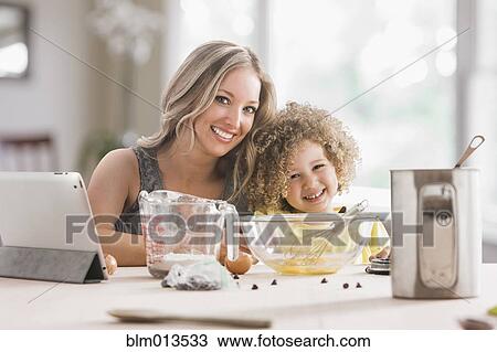 Mother and daughter baking together View Large Photo Image Stock Image - Mother and daughter baking together. Fotosearch