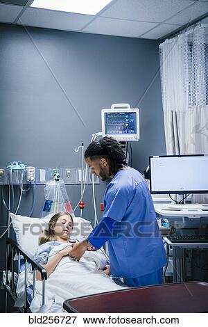 Stock Photo - Nurse holding hand of patient in hospital. Fotosearch