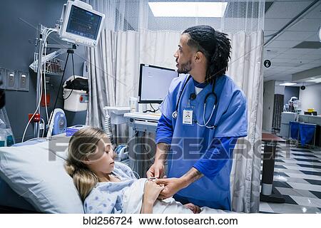 Nurse placing finger monitor on patient View Large Photo Image Picture - Nurse placing finger monitor on patient. Fotosearch
