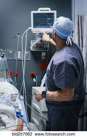 Nurse pressing button on monitor for patient View Large Photo Image Stock Image - Nurse pressing button on monitor for patient. Fotosearch