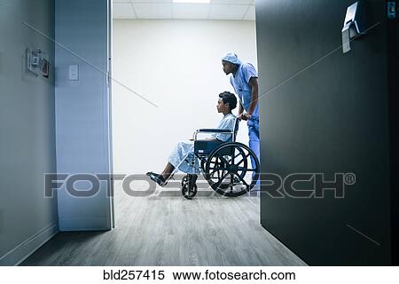 Stock Photography - Nurse pushing boy in wheelchair. Fotosearch