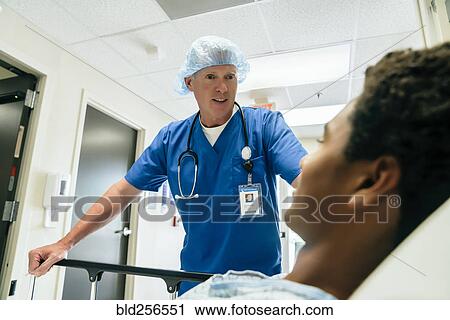 Nurse talking to boy in hospital bed View Large Photo Image Stock Image - Nurse talking to boy in hospital bed. Fotosearch