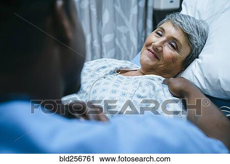 Nurse talking to patient in hospital bed View Large Photo Image Stock Image - Nurse talking to patient in hospital bed. Fotosearch