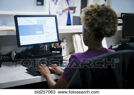 Nurse using computer in hospital View Large Photo Image Stock Image - Nurse using computer in hospital. Fotosearch