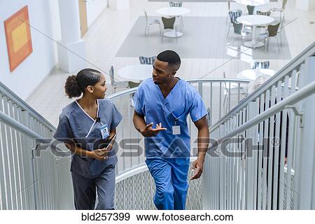 Nurses climbing staircase and talking View Large Photo Image Stock Photo - Nurses climbing staircase and talking. Fotosearch