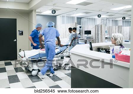 Stock Photography - Nurses pushing hospital gurney. Fotosearch