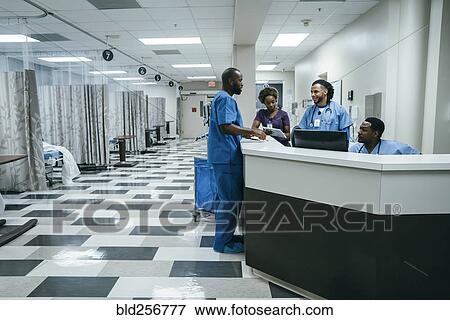 Stock Photo - Nurses talking in hospital. Fotosearch
