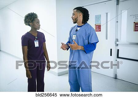 Stock Photography - Nurses talking in hospital. Fotosearch
