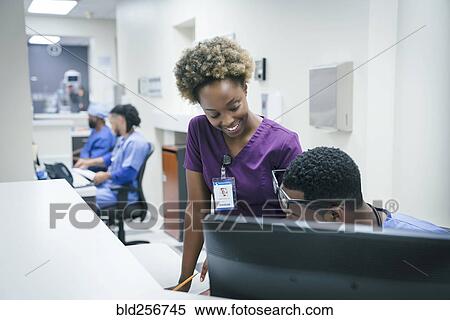Stock Photography - Nurses talking in hospital. Fotosearch