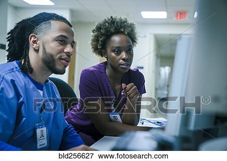 Stock Photo - Nurses using computer. Fotosearch