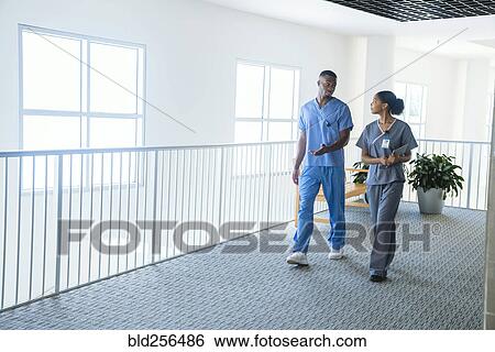Stock Photograph - Nurses walking and talking. Fotosearch