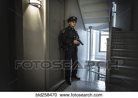 Older Caucasian policewoman holding gun in apartment staircase View Large Photo Image Stock Image - Older Caucasian policewoman holding gun in apartment staircase. Fotosearch