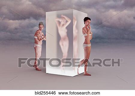 Stock Photograph - Older woman walking into cube changing to younger woman. Fotosearch