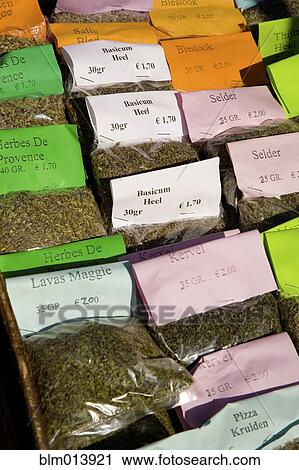 Stock Image - Packages of herbs for sale in market. Fotosearch
