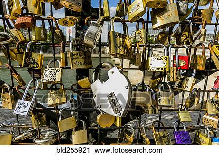 Stock Image - Padlocks on fence at river. Fotosearch