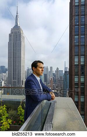 Pensive Caucasian businessman leaning on urban rooftop View Large Photo Image Stock Image - Pensive Caucasian businessman leaning on urban rooftop. Fotosearch
