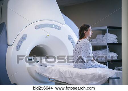 Pensive Caucasian girl sitting on scanner table View Large Photo Image Picture - Pensive Caucasian girl sitting on scanner table. Fotosearch