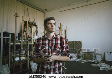 Pensive Caucasian man texting on cell phone View Large Photo Image Stock Photograph - Pensive Caucasian man texting on cell phone. Fotosearch