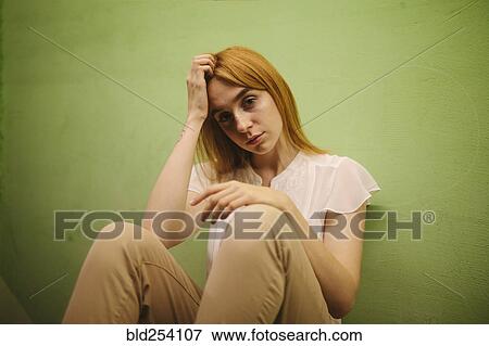 Pensive Caucasian woman leaning against wall View Large Photo Image Stock Photo - Pensive Caucasian woman leaning against wall. Fotosearch