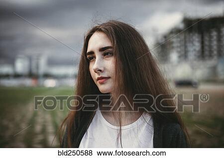 Stock Photo - Pensive Caucasian woman outdoors. Fotosearch