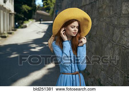 Pensive Caucasian woman wearing hat near stone wall View Large Photo Image Stock Image - Pensive Caucasian woman wearing hat near stone wall. Fotosearch