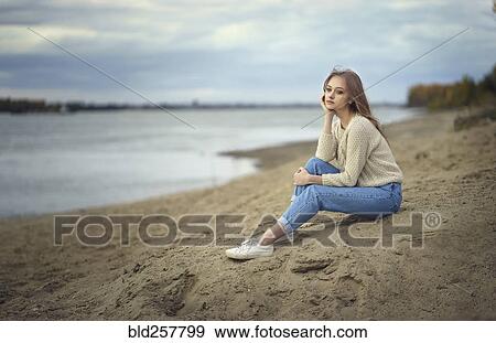 Pensive woman sitting on beach View Large Photo Image Stock Photo - Pensive woman sitting on beach. Fotosearch