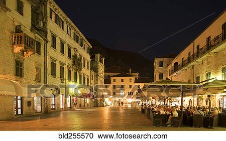 Stock Image - People at outdoor restaurant at night. Fotosearch