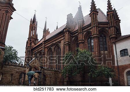 People carrying umbrellas near church View Large Photo Image Stock Image - People carrying umbrellas near church. Fotosearch