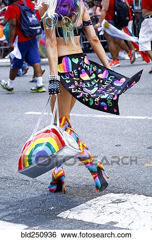 Person wearing high heel boots carrying purse in pride parade View Large Photo Image Stock Photograph - Person wearing high heel boots carrying purse in pride parade. Fotosearch