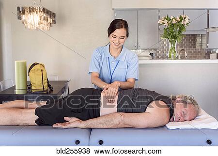 Physical therapist massaging back of man View Large Photo Image Stock Photo - Physical therapist massaging back of man. Fotosearch