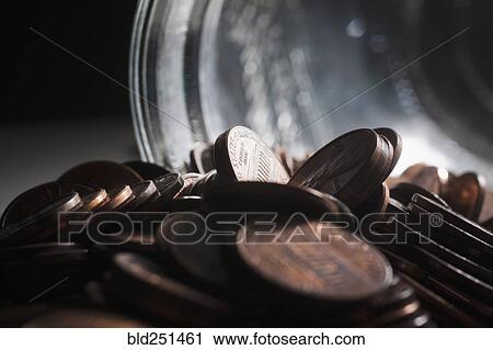 Stock Image - Pile of pennies near jar. Fotosearch