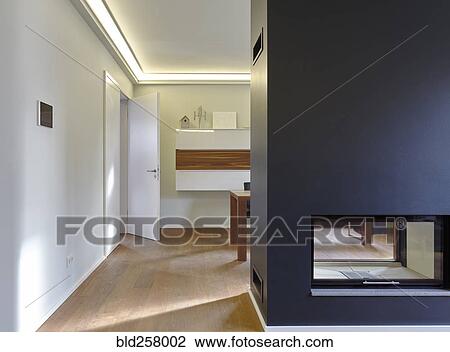 Stock Image - Plank floor and modern fireplace in home. Fotosearch